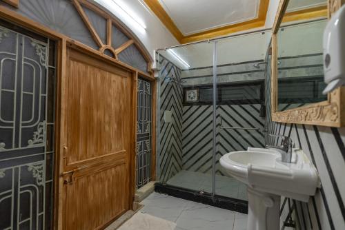a bathroom with a sink and a shower at Wanderlust A Boutique Homestay in Udaipur
