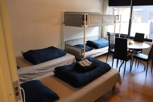 a room with three bunk beds and a table at Neckelmanns BnB, Room 36 