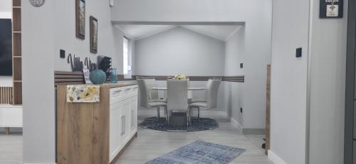 a kitchen with white cabinets and a table and chairs at Villa View in Neum
