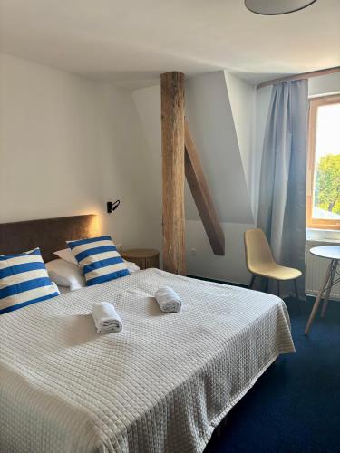a bedroom with a bed with two towels on it at SZiGET23 in Ábrahámhegy
