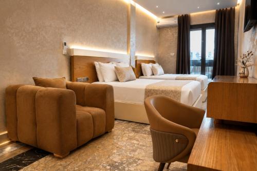 a hotel room with a bed and a couch at Hôtel Aguelmam in Khenifra