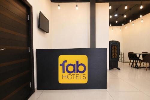 a sign for a foto h hotels in a room at FabHotel Shree I in Indore