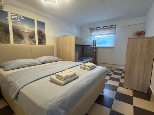 a bedroom with a bed with two towels on it at Zupan apartments in Ližnjan