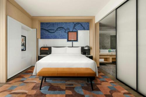 a hotel room with a bed and a bathroom at Le Méridien Changzhou in Changzhou
