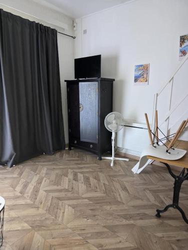 a room with a wooden floor and a black curtain at RUFFEC 14 1D in Ruffec