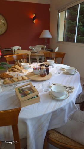 a table with a white table cloth on it at au fil de l'oust in Rohan