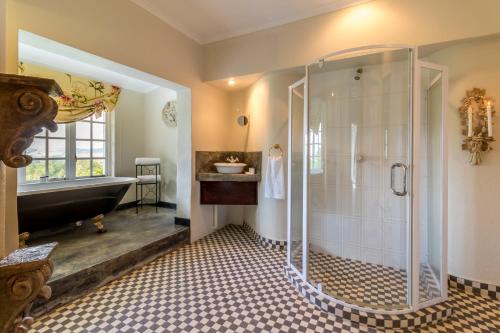a bathroom with a shower and a sink and a tub at Blue Mountain Estate in Hazyview