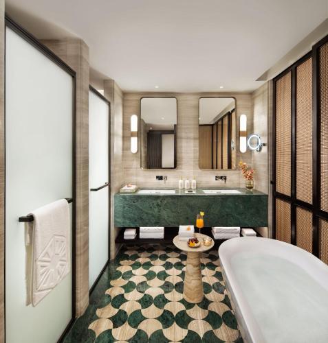 a bathroom with a tub and a sink at Taj Palace, Lucknow in Lucknow