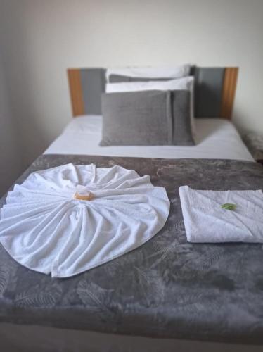 two towels are sitting on top of two beds at Hotel Linassi in Cruz Alta