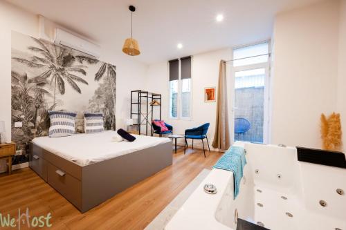 a bedroom with a bed and a living room at Charmant cocon avec jacuzzi - Bordeaux Centre in Bordeaux