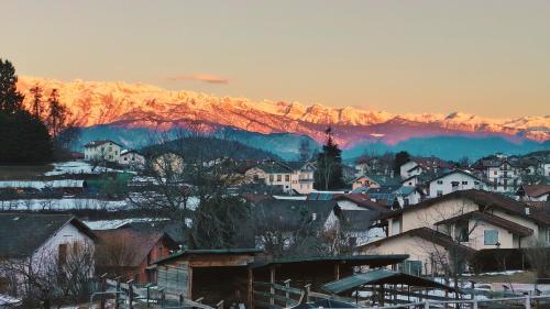 a city with houses and mountains in the background at Albergo Garni Villa Lory in Baselga di Pinè
