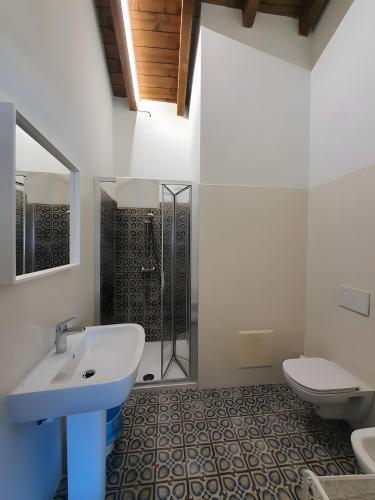 a white bathroom with a sink and a toilet at La Cà de' mi Vecc in Fino Mornasco