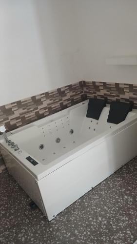 a white bed sitting on the floor in a room at Villa de 3 chambres avec jaccuzzi in Porto-Novo