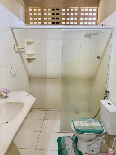 a bathroom with a shower and a toilet and a sink at Casa Alemao Águas Belas in Cascavel