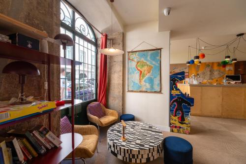 a room with a table and chairs in a room at Yes Lisbon Hostel in Lisbon