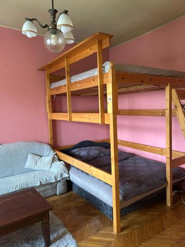 a room with two bunk beds and a couch at Mozaik Apartman in Kalocsa
