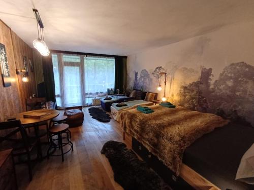 a bedroom with two beds and a table and a desk at Grubhof Treetops in Sankt Martin bei Lofer