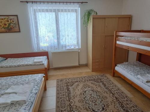 a room with three bunk beds and a window at Apartmány pod Suchým Vrchem - Dolní Morava - Buková hora - Orličky in Orličky