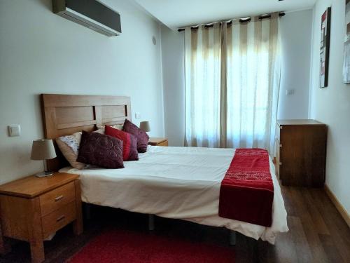 a bedroom with a large bed and a window at Shell Bay Retreat in São Martinho do Porto