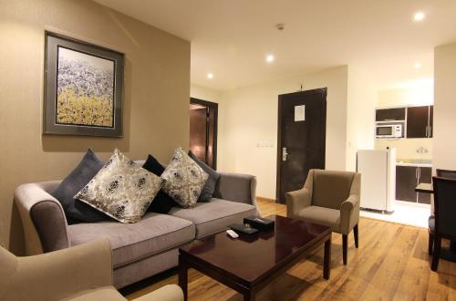 a living room with a couch and a table at Aliah Towlan Palace in Riyadh