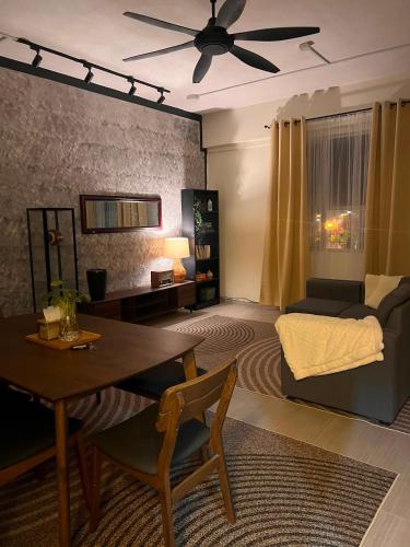 a living room with a couch and a table at The Teduh Homestay By Rumah Mimpi in Kertih