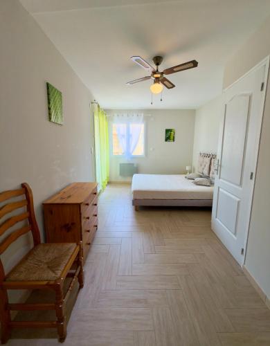 a bedroom with a bed and a ceiling fan at Maison classée 3 étoiles avec garage et 2 terrasses in Arles-sur-Tech