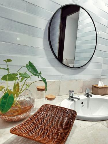 a bathroom with a sink and a mirror at The Teduh Homestay By Rumah Mimpi in Kertih