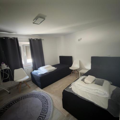 a living room with two beds and a couch at Stilvolle Wohnung im Erdgeschoss in Kolbermoor