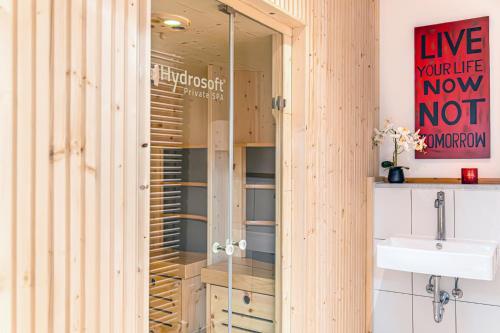 a bathroom with a glass shower and a sink at Schlossberghotel Oberhof in Oberhof