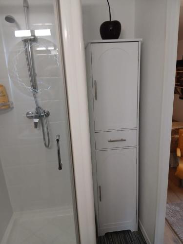 a white cabinet with drawers in a room at La Terrasse Salon de The in Montmorillon