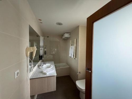 a bathroom with a sink and a toilet at Hotel Balneario de Gravalos in Grávalos