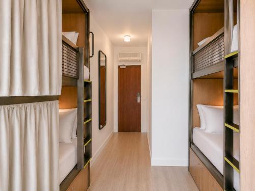 a room with bunk beds and a hallway at Hôtel Chromatics & Restaurant Hill Club by HappyCulture in Lyon