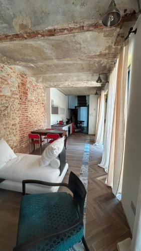 a living room with two beds and a table at Residenza SOGNO in Biella