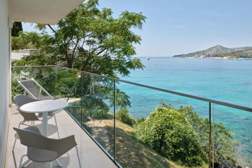 a balcony with a table and chairs and the ocean at Maistra Select Mlini Villas and Apartments in Mlini