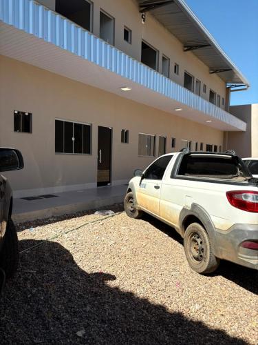 a white truck parked in front of a building at Estúdio J&C 05 A in Primavera do Leste