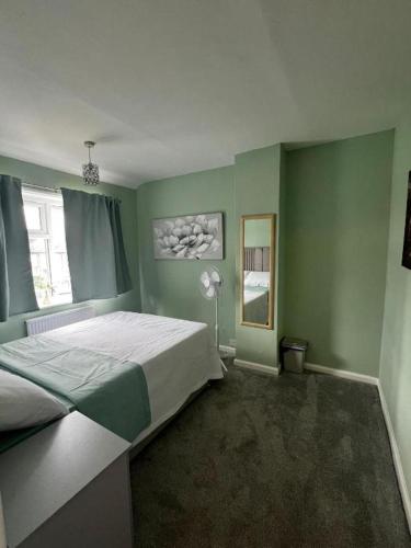 a bedroom with a large bed and a window at Oakley Court Room in Wallington