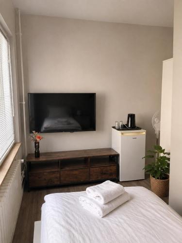 a bedroom with a large flat screen tv on the wall at Laroni in Duisburg