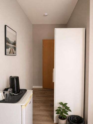 a kitchen with a refrigerator and a coffee maker on a counter at Laroni in Duisburg