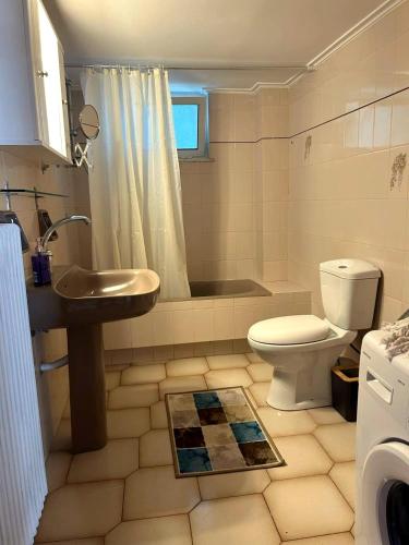 a bathroom with a sink and a toilet and a tub at Kastelia in Yéfira