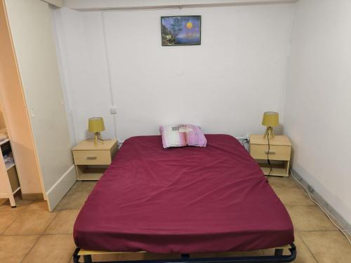 a room with a bed with a purple sheet on it at Sweet villa view 26 in Nyons