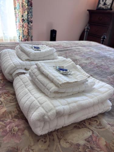 a group of towels sitting on top of a bed at Cannon House Retreat in Fayetteville