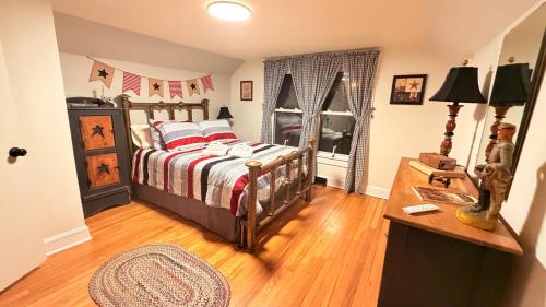 a bedroom with a bed and a table in it at Cannon House Retreat in Fayetteville