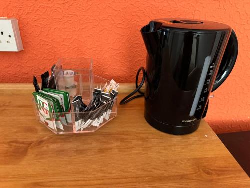 a black toaster sitting on a table next to a container at Mirage Hotel in Blackpool