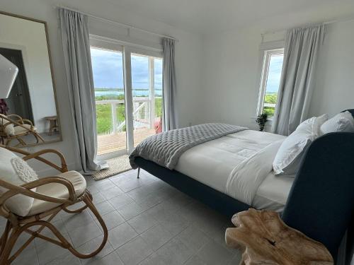 a bedroom with a bed and a chair and a window at The View Villa in Hartswell