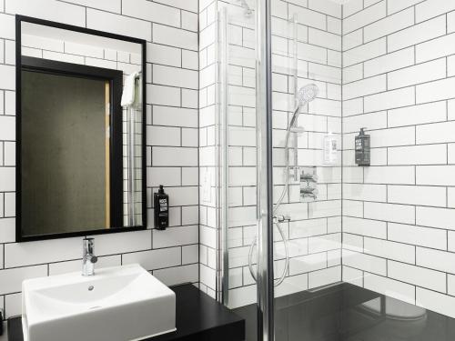 a white bathroom with a sink and a mirror at ibis Bridgwater, M5 Jct23 in Bridgwater