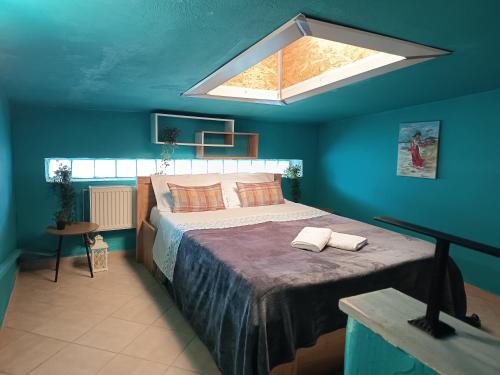 a bedroom with a large bed with a large skylight at Chéz Vasŏ ** leisure maisonette** in Kassandra