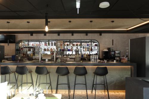 a bar at a restaurant with stools at Hotel Aurelia in Aldingen