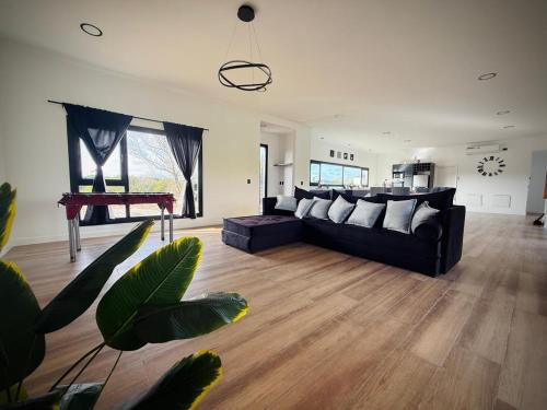 a living room with a black couch and a table at North beach Pinamar in Pinamar