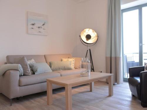 a living room with a couch and a table at Ohlerich Speicher App_ 20 in Wismar