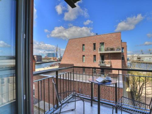 a balcony with a view of a brick building at Ohlerich Speicher App_ 14 in Wismar